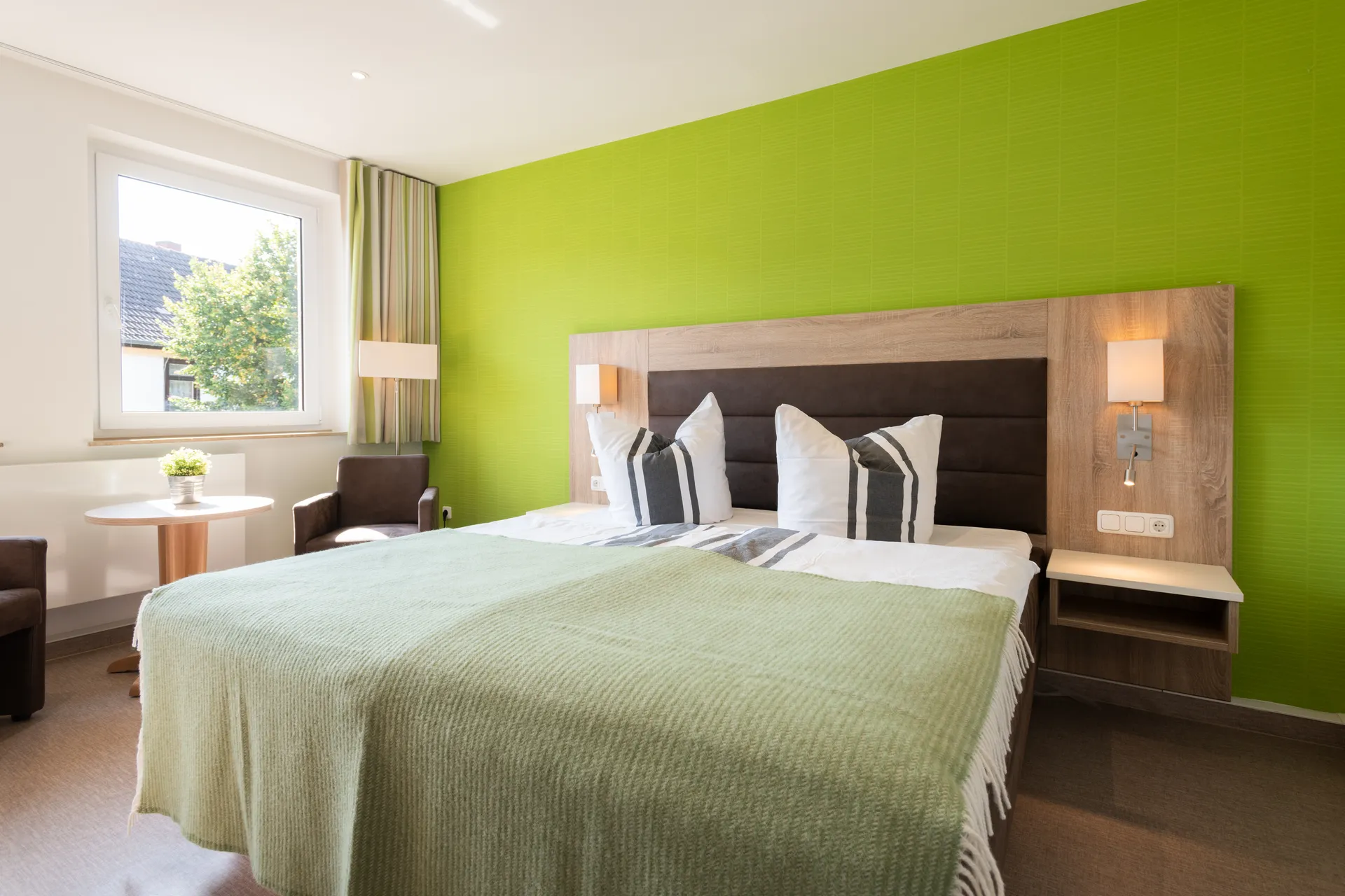 Möbliertes Schlafzimmer im Apartment des Cityapart Heiligenstadt mit Doppelbett und Fensterblick im Eichsfeld